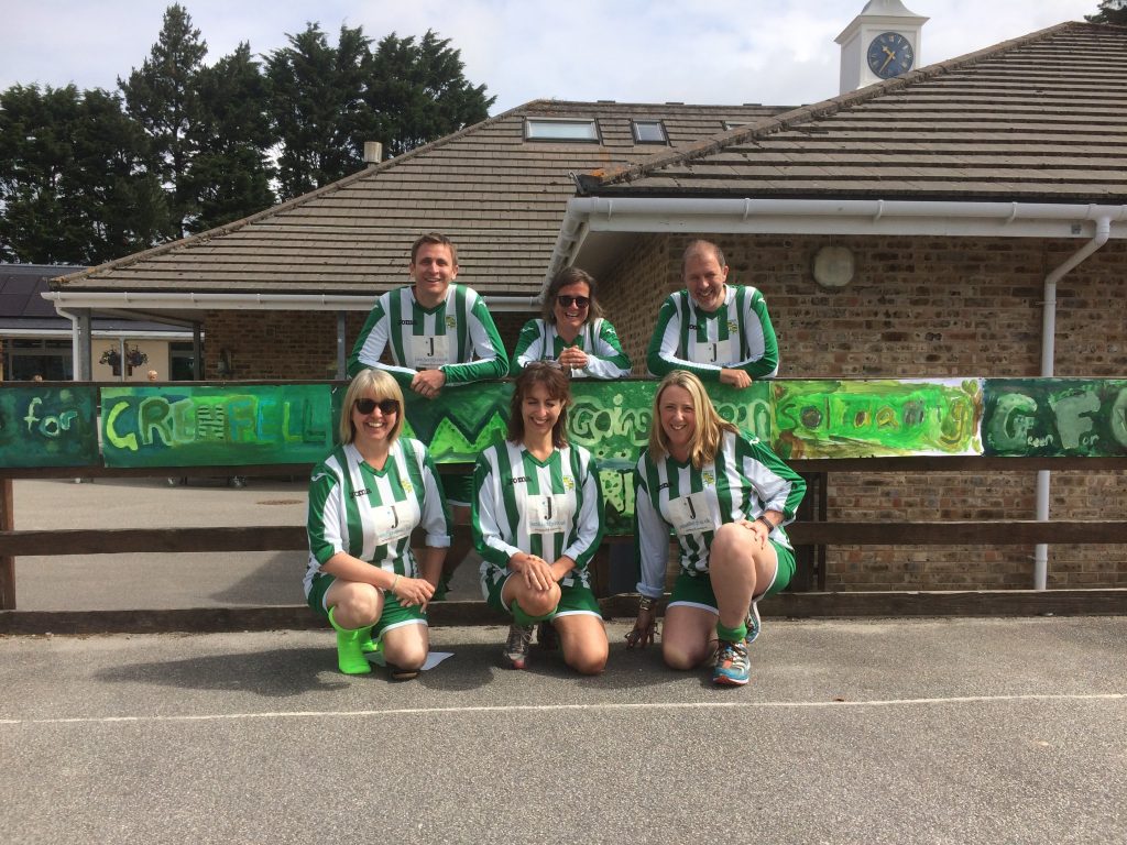 A photograph of teachers dressed in green football strips to Go Green for Grenfell. 